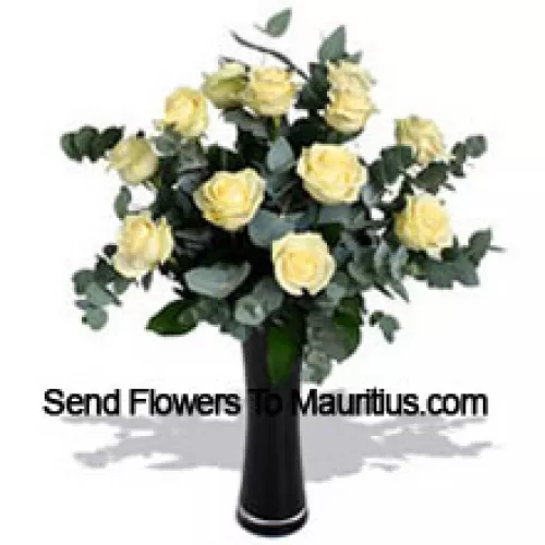 12 White Roses With Some Ferns In A Vase